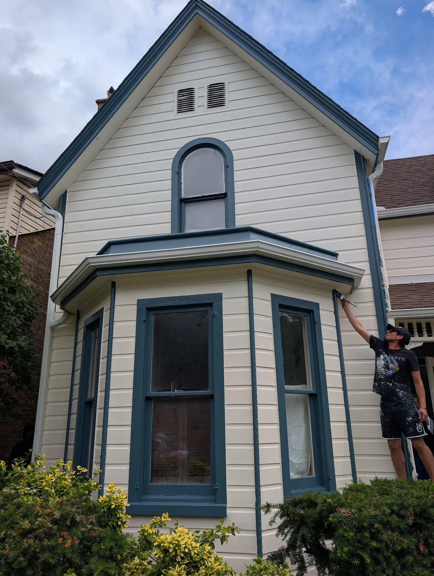 Victorian bay window repainted with navy and cream trim by Pelican Painters