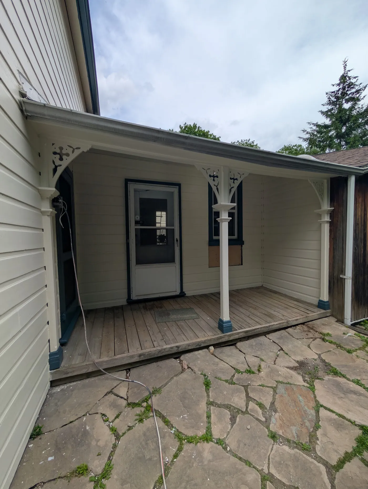 Covered porch with freshly painted white columns